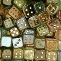 many different colored dices with holes in them