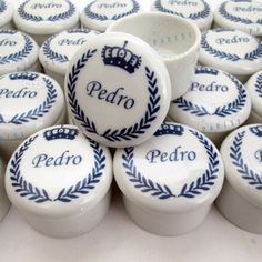 many white and blue ceramic objects with the word pedro written on them in black lettering