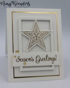 a white card with a star on it and the words season's greetings