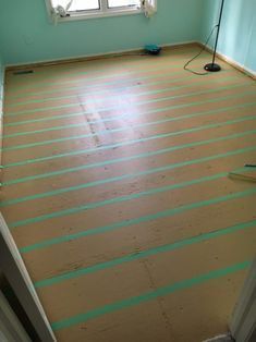 an empty room with wood flooring being installed