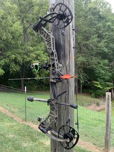 an arrow and bow are attached to a telephone pole