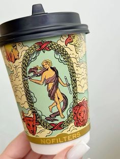 a hand holding a coffee cup with an image of a woman on the front and side