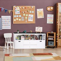 a child's playroom with toys, bookshelves and pictures on the wall