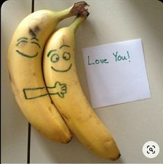 two bananas with faces drawn on them next to a note that says i love you