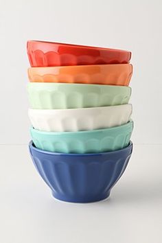 a stack of colorful bowls sitting on top of each other