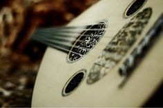 a close up of an acoustic guitar with strings