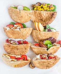 a pile of food sitting on top of a white table next to some fruit and vegetables