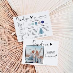 two cards with photos on them sitting in front of a wicker basket filled with flowers