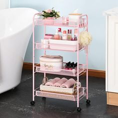 a bathroom with a tub and pink shelving unit