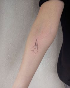 a woman's arm with a small tattoo on the left side of her arm