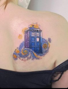 a woman with a tattoo on her shoulder has a blue tardish in the sky