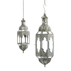 two metal lanterns hanging from chains on a white background, each with an intricate design