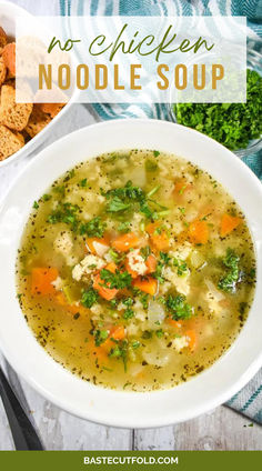 a white bowl filled with chicken noodle soup next to crackers and parsley