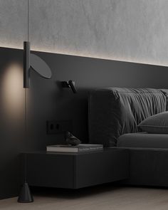 a black couch sitting in a living room next to a lamp