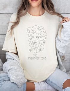 We love our comfortcolors tshirt featuring the Gorgon Queen, Medusa!  She rocks this along with the phrase "Misunderstood" and hope you will too!  Perfect for someone who wants to show their feminism or feministic spirit in an understated, minimalist way.  Let's reclaim Medusa's story and as a symbol of power & strength and use her image as a symbol of protection against evils! * Q U I C K * F A C T S * ✺ Pre-shrunk 100% US cotton for size retention using cotton that is ethically grown and harve Greek Tshirt Designs, Greek Life Sweatshirts, Light Academia Clothing, Selling T Shirts, Queen Medusa, Greek Mythology Shirt, Cheap Witchy Graphic Print T-shirt, Academia Clothing, Cheap Witchy T-shirt With Graphic Print