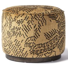 an upholstered foot stool with black and tan designs on the top, sitting against a white background