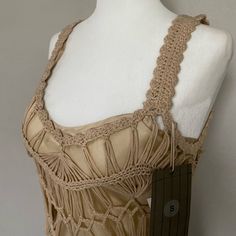 a mannequin wearing a dress with crochet on the neck and shoulders