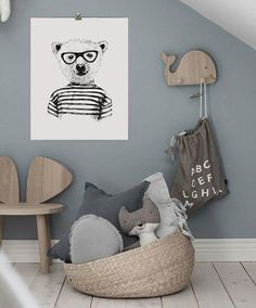 a child's room decorated in grey and white with an animal illustration on the wall