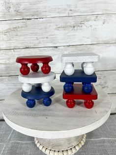 two wooden toy train cars sitting on top of a white table next to each other