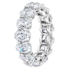 a large white diamond ring with rows of round cut diamonds on the inside of it