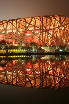 the bird's nest stadium is lit up at night