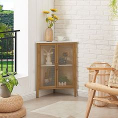 a living room area with wicker furniture and flowers on the window sill,