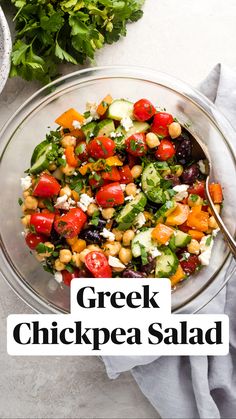 greek chickpea salad in a glass bowl with the title overlay above it