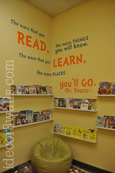 the children's room is decorated in yellow and orange with pictures on the wall