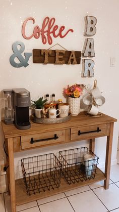 a coffee bar and tea station in the corner of a room with white tile flooring