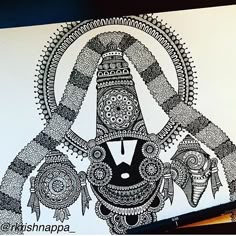 an intricately designed piece of artwork is displayed on a white sheet with black ink