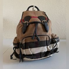 Burberry Housecheck Rucksack Backpack. Interior Is Lined Fabric, Comes With A Zip Pocket And A Slip Pocket. Exterior Is Made With Canvas Fabric, Features Leather Trims, Leather Drawstring, Silver Metal Fittings, Flap Cover, Two Sides Zip Pockets, One Front Zip Pocket, Double Back Straps. Condition: Interior Is Neatly Used, Mild Storage Odor, Shows Minimal Stains, No Rips No Tear. Exterior Is Neatly Used, Minimal Signs Of Aging On Leather Trims, Creasing On Fabric, Scratches On Hardware, Zips Sho Cloth Backpack, Backpack Outfit, Rucksack Backpack, Burberry Bag, Back Strap, Leather Trims, Canvas Fabric, Metallic Silver, Zip Pockets