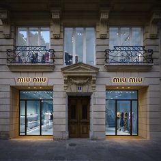 the entrance to a building with many windows