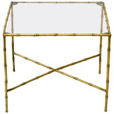 a bamboo table with glass top and metal legs