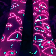 neon pink and blue patterned leggings with black light in the dark, on display