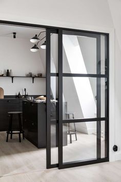 an open kitchen and dining room area with sliding glass doors that lead to the loft