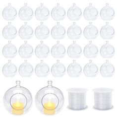 a bunch of clear glass ornaments and some white spools next to each other