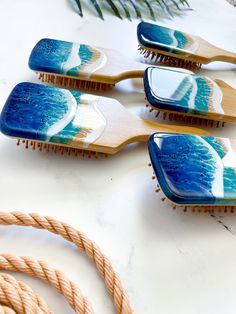 Listing is for only 1 hair brush, not a set! Are you a beach lover or know a beach lover who needs everything beach? These are the perfect gift and a great way to appease the eye with the calming touch of the many layers of waves! These hair brushes are made from bamboo and natural rubber, and not only are they a more sustainable option for the environment in terms of them being plastic free (even the cushioning bit) and vegan, they are a better option for healthier, shinier hair. Perfect for an Beach Resin Art, Bamboo Hair Brush, Wooden Hair Brush, Beach Resin, Detangling Hair Brush, Paddle Brush, Beach Bridal, Hair Brushes, Beach Lover