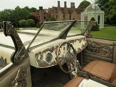 the interior of an old fashioned car in front of a house