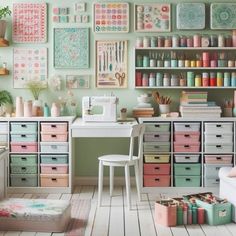 a sewing room with lots of crafting supplies on the wall and drawers in front of it