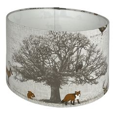 a lamp shade with foxes under a tree