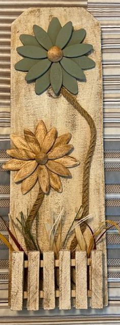 a wooden wall hanging with flowers on it