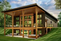 a large house sitting on top of a lush green field next to a tree filled forest