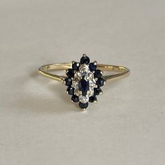 Vintage 10K Gold Blue Spinel and Diamond Accent Ring, Size 5.5, 1.7grams Size: 5.5 Weight: 1.7 grams Main Stone: Blue Spinel (1 Main Stone, 12 Accent Stones) Color: Black Cut: Marquise, Round Size Main Stone: ca. 5.5mm x 4mm Secondary Accent Stones: Diamond (8 stones) Markings: 10K Band: 10K Solid Yellow Gold Bandwidth: xxmm at smallest point Tested: Olympus GoldXpert Precious Metal Analyzer- tested 10K, Presidium Gemtester ll - tested Spinel and Diamond (testing performed by 3rd party) Conditio Family Heirloom Ring, Heirloom Rings, Blue Spinel, Spinel Ring, Diamond Accent Ring, Vintage Fans, Pretty Jewellery, Unique Engagement Rings, 10k Gold