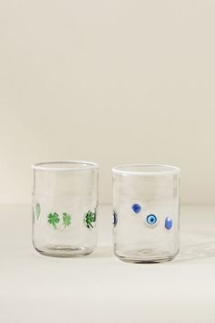 two glasses with green and blue designs on them