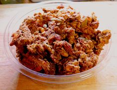 a bowl filled with granola sitting on top of a wooden table