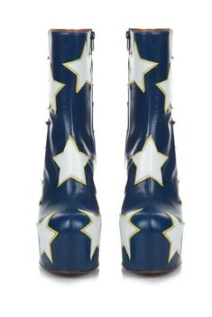 Smooth navy blue leather platform boots with shiny white and yellow patent leather star-shaped patch design. contrasting star pattern adorns body of shoe, platform, and leather-covered cylinder block heel. star patches are attached with tonal stitching and display raw suede underlay around the edges. this boot is designed with a top seam, making it stunningly seamless where body of shoe meets platform. features narrow ankle for flattering fit and tonal zip closure at inner sides. includes reinforced heel counter and toe box for support and comfortable wear. smooth reddish tan leather interior lining and insole. brown leather outsole and brown heel tap. Colorful Platform Boots, Blue High-top Platform Boots, Celestial Boots, Platform Boots With Stars, Ankle Boots Stars, Navy Boots, Heel Tap, Nashville Style, Blue Boots