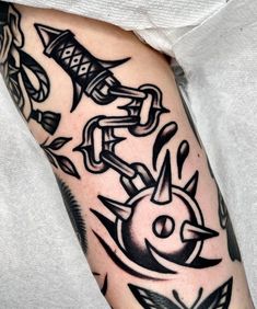 a man's arm with tattoos on it, and an arrow in the middle