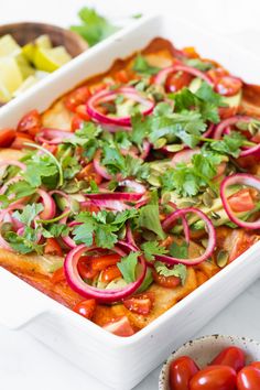 A colorful vegan enchiladas dish topped with avocado, cherry tomatoes, red onion, cilantro, and seeds. Cashew Cream Sauce, Food Inc, Red Enchilada Sauce, Cashew Cream, Red Rice, Pickled Red Onions, Canned Black Beans, Enchilada Sauce, Grape Tomatoes