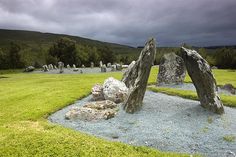 some rocks in the middle of a grassy field