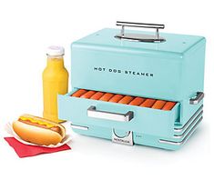 a hot dog maker with mustard and ketchup next to it's buns